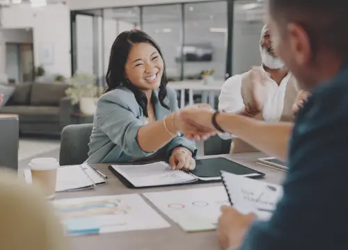 Woman and man shaking hand to represent collaboration and partnership.