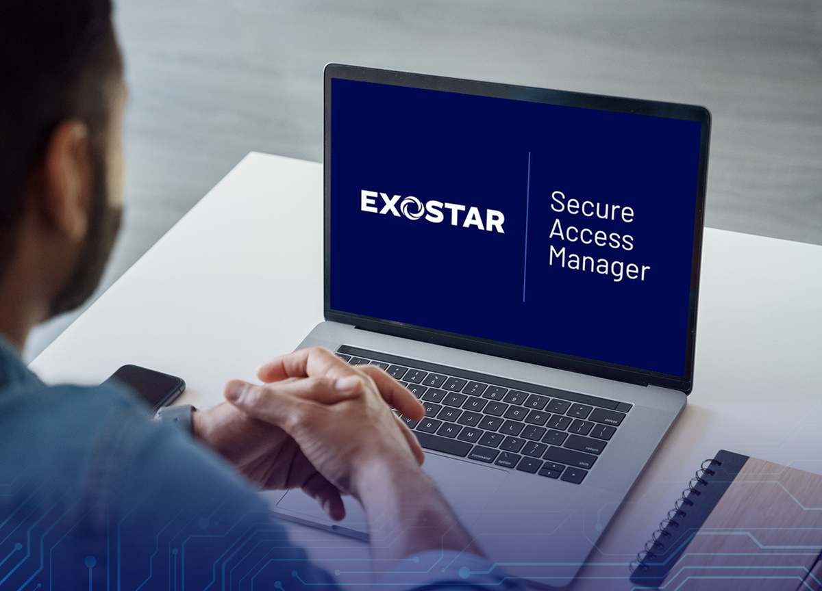 Man in front of laptop watching Exostar Secure Access Manager video