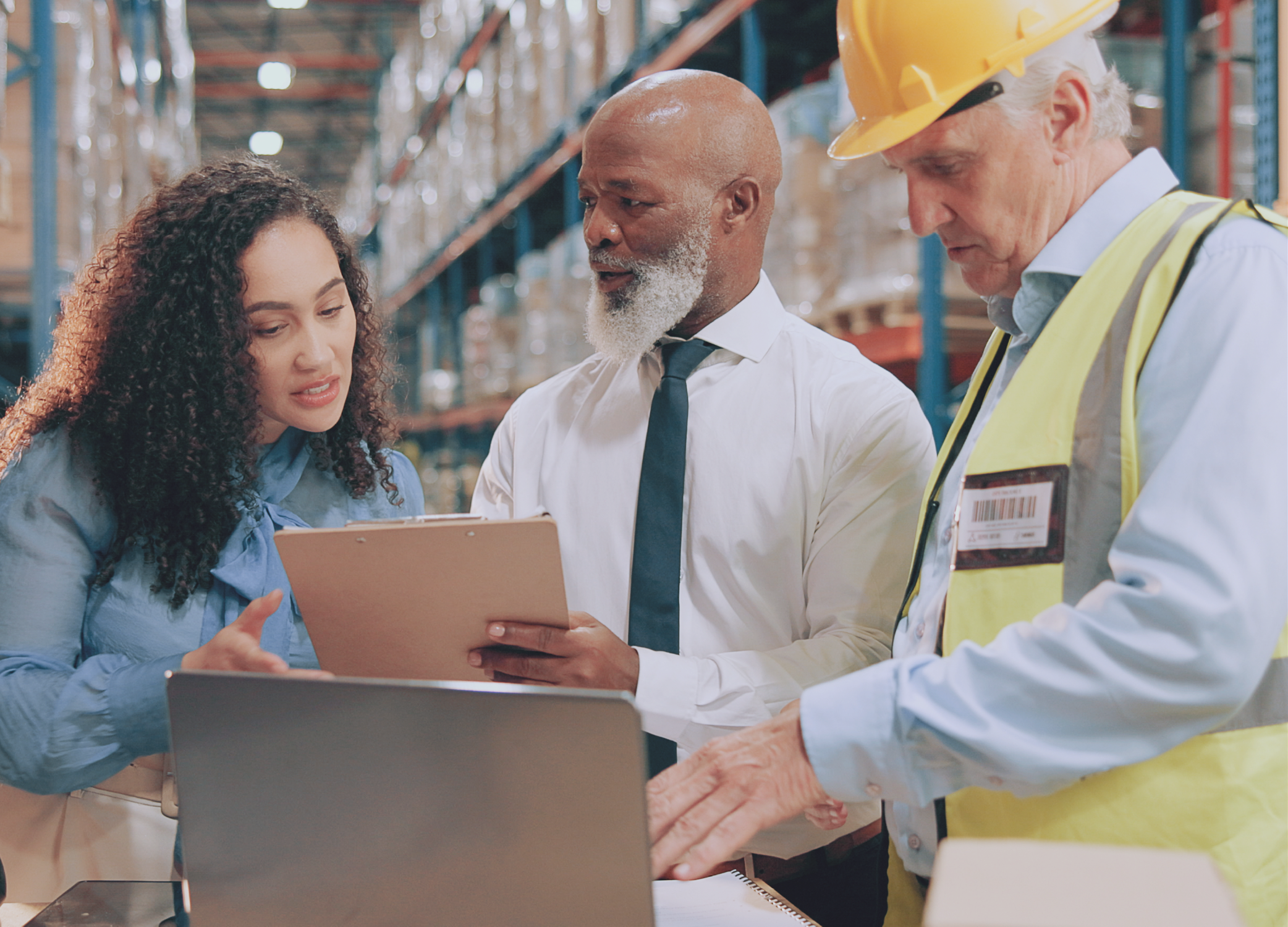 Three employees working in a warehouse as part of the supply chain.