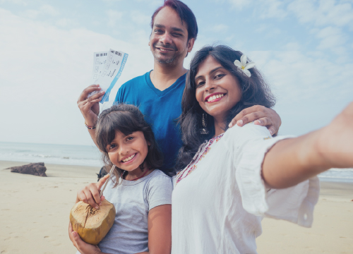 Private time off represented by two parents and a child on a beach on vacation.