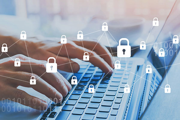 Close up image of hands typing at a laptop with lock icons showing secure access.