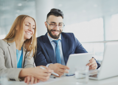 Access One image for the website of two people smiling and looking at a tablet.