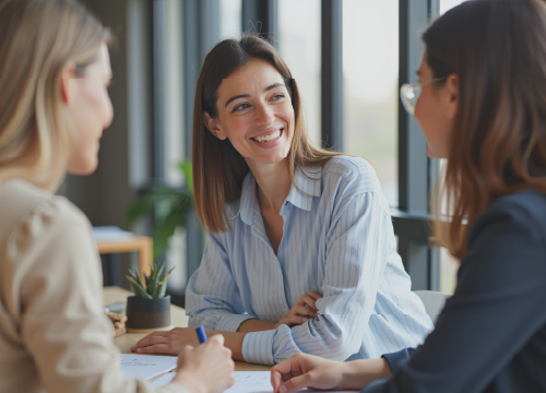 Three women talking around a table in an image used for Access One.