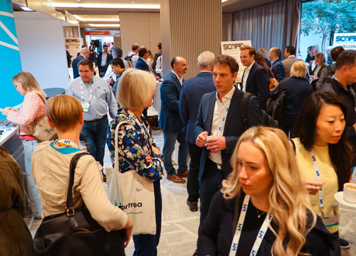Photo from SCOPE Europe 2025 showing the Exostar booth and attendees.